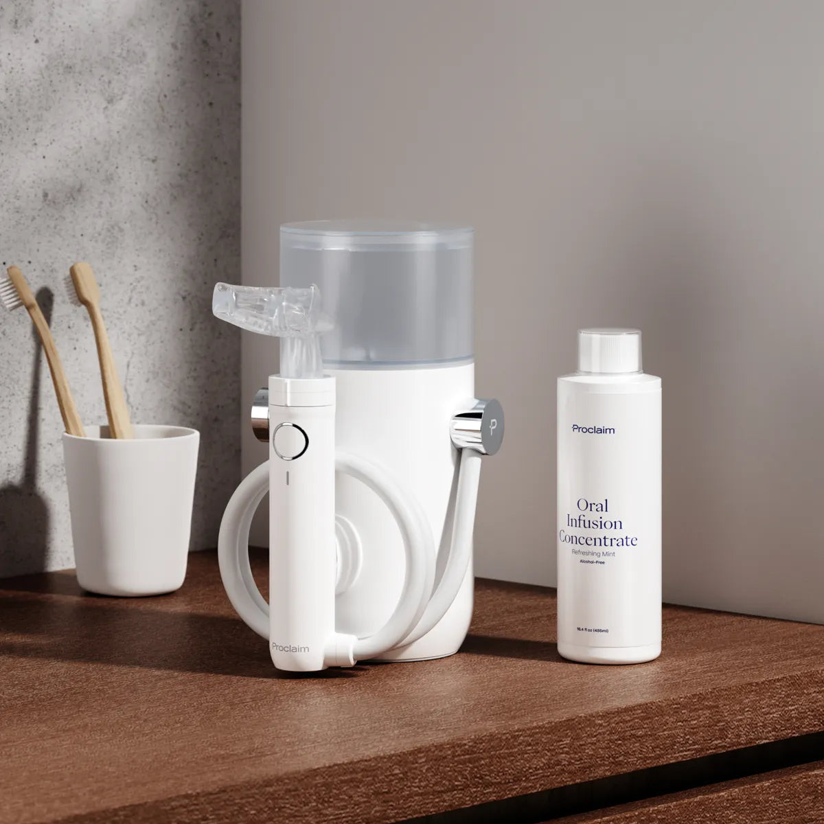 The Proclaim Oral Infusion Concentrate next to the Proclaim Custom-Jet Oral Health system on a wood countertop in a bathroom